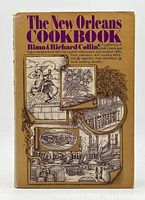 Front cover of the hardcover cookbook showing title and illustrated dust jacket with New Orleans themes.