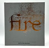 Front cover of the gray hardcover book with gold embossed title 'From Spark to Flame' by Oivind Berg, showing fire ember graphics.