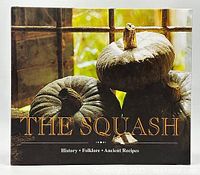 Front cover photo of 'The Squash' book showing three squash in front of a window with sunlight.