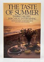 Front cover of the book showing the title The Taste of Summer with a beach table setting at sunset.