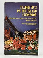Front cover of Trader Vic's Pacific Island Cookbook showing title and colorful food arrangement illustration.