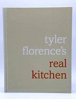 Front cover of Tyler Florence's Real Kitchen cookbook showing title on beige background.
