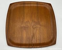 Front view of square teak tray showing grain and shape