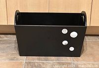 Front view of black fibreboard storage box with dot accents