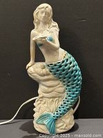 Full view of ceramic mermaid light showing cord and tail cutouts