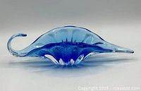 side profile showing oblong shape and curl