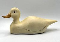Left side view of cream wood duck figurine