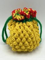 front view of crocheted pineapple bag showing texture and drawstring