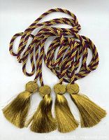 Both cords coiled showing four tassels and knot details