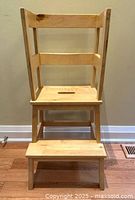 Front view showing two steps, handle cut-out and three raised sides