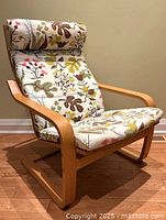 Front-left view of IKEA POÄNG armchair displaying frame and cushion design