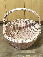 Full view of painted wicker basket, showing shape and weave