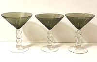 Front view of three smoky martini glasses in a row