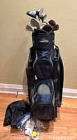 Bennington cart bag with clubs, rain cover and accessories visible