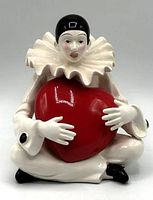 Front view showing Pierrot clown holding red heart