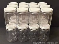 Front view showing stacked arrangement of 24 clear plastic jars with white lids