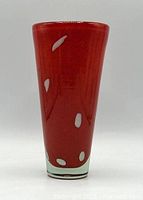 Front view of red glass vase with white dots