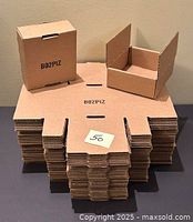 Stack of flat boxes with one assembled and one partially assembled on top