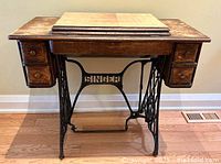 Front view of Singer wood cabinet on iron base