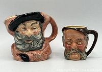 Front view of both Falstaff toby mugs