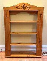 Front view showing entire knotty pine shelving unit and shelf count