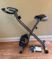 Side view of assembled Xterra FB150 bike with accessories on floor