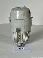 Side view of the cylindrical Escape Pod showing sticker detailing and surface wear