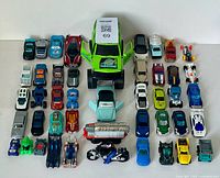 Photo showing entire lot of varied toy cars and vehicles arrayed neatly for visual inventory