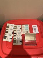 Photo of eight Microsoft Windows floppy disks with partial original packaging on red surface