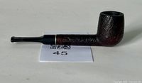 Side view of the vintage Empire tobacco pipe showing its textured wooden bowl and black mouthpiece.