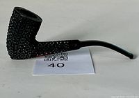 Side angle photo showing textured black rusticated bowl and shank, smooth natural wood accent on the side, and curved black stem.