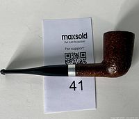 Side view of the vintage tobacco pipe showing the textured brown bowl, silver band, and black stem.