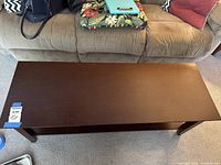 Top view of the rectangular coffee table showing smooth mahogany finish and plain design