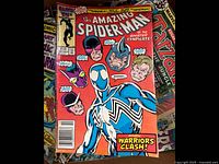 Comic books with focus on The Amazing Spider-Man issue showing colorful cover art