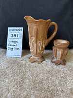 Photo of two vintage caramel ceramic vases on carpet showing full set, contrasting size of both vases, with sales card indicating description