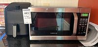 Farberware microwave oven next to Instant Vortex air fryer on countertop