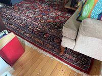 Overall view of rug in living area next to sofa and coffee table