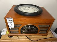 Photo of Crossley retro radio turntable with CD player and integrated clock on wooden casing.