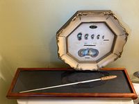 Signed Keith Lockhart conductor's wand with wooden handle displayed in a glass-topped rectangular wooden case, placed below the framed shell and pearl display.