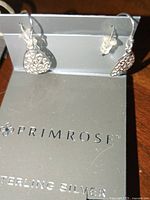 Sterling silver teardrop filigree earrings displayed on Primrose branded card