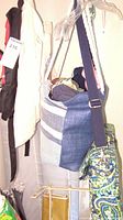 Large blue and white striped canvas tote bag with dark blue shoulder strap in hanging position