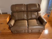 Front view of loveseat showing two-seat design, back cushions, arms and seat cushions under even lighting