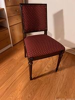 Front angled view of the vintage accent chair showing the mahogany frame and red upholstery in good condition.