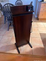 Front view of the vintage Corby Classic Trouser Press showing wooden finish and control panel with timer and switch.