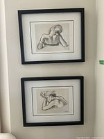 Two vertically stacked framed black and white prints by Van Hove showing women in contemplative poses.