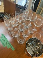 Full view of all glassware including wine glasses, brandy glasses, champagne glasses, wine decanter, and ice bucket