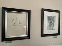 Photo showing two framed prints mounted on a beige wall, framed Picasso print on the left and framed Matisse print on the right.