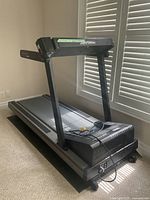 Full view of Life Fitness treadmill showing running belt, frame, and power cord