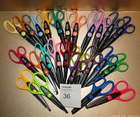 All 25 pairs of colorful Fiskars paper edger scissors arranged in a fan shape.
