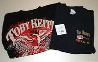 Two Toby Keith men's XL black t-shirts, one showing the front of each shirt including tour graphics.